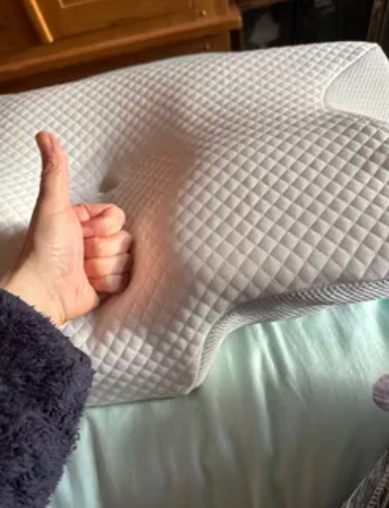 Smiling woman lifting pillow